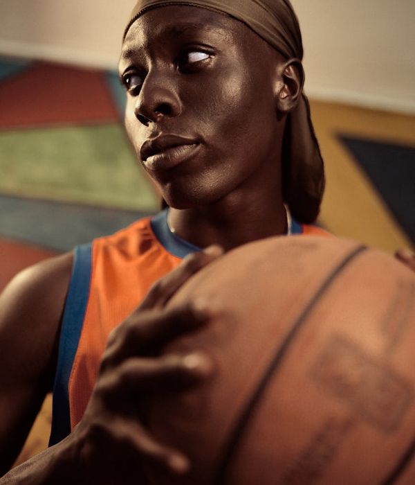 Man in a focused pose during a strength exercise in a dark room.
